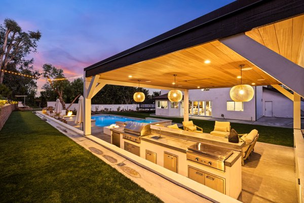Project Laguna - Complete luxury outdoor transformation featuring a custom-built pool and elevated spa with LED lighting and modern water features. The space includes a sleek fire pit lounge, covered patio with a built-in BBQ and entertainment area, and expansive hardscape using premium materials. Professionally designed landscape lighting and tiered planting bring the hillside to life, creating a resort-style ambiance perfect for entertaining and relaxation. Project Laguna - Complete luxury outdoor transformation featuring a custom-built pool and elevated spa with LED lighting and modern water features. The space includes a sleek fire pit lounge, covered patio with a built-in BBQ and entertainment area, and expansive hardscape using premium materials. Professionally designed landscape lighting and tiered planting bring the hillside to life, creating a resort-style ambiance perfect for entertaining and relaxation.