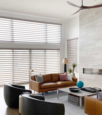 Whole Home Custom Shades - This home had an open floor plan that let in so much gorgeous light, but the homeowner wanted to protect furnishings and flooring from sun bleaching. On the angled windows we did NewStyle Hybrid Shutters in Crisp White (3-1/2” louvers) and for all the other windows we went with Pirouette 5” Stria Fresh Taupe for room darkening and an EasyRise cord. The result was simply beautiful! Whole Home Custom Shades - This home had an open floor plan that let in so much gorgeous light, but the homeowner wanted to protect furnishings and flooring from sun bleaching. On the angled windows we did NewStyle Hybrid Shutters in Crisp White (3-1/2” louvers) and for all the other windows we went with Pirouette 5” Stria Fresh Taupe for room darkening and an EasyRise cord. The result was simply beautiful!