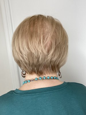 Short women’s haircut by Tyreema - This client has thin hair and wanted a cut to give her hair a fuller, thicker look. It’s amazing what taking a few inches off can do! Book your haircut today!!