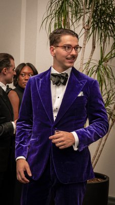 Purple Velvet Black Tie - This tuxedo was designed with one goal, to stand out in a refined and luxurious way, definitely a win in our books. Few fabrics scream luxury like velvet, especially such a rare, soft, and confident one such as this deep purple that seeks to be noticed by refined taste. Purple Velvet Black Tie - This tuxedo was designed with one goal, to stand out in a refined and luxurious way, definitely a win in our books. Few fabrics scream luxury like velvet, especially such a rare, soft, and confident one such as this deep purple that seeks to be noticed by refined taste.