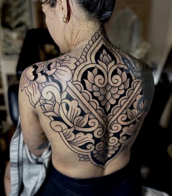 Blackwork / Ornamental Tattoos - Blackwork is a style that involves solid black ink. Designs often feature patterns and geometric designs such as mandalas and dot work. They also may incorporate cultural motifs such as tribal designs, Māori patterns, and Celtic knots. Ornamental tattooing is similar to sacred geometry, but encompasses all patterns whether they be floral or ornate. The ornamental style focuses more on creating a full spectrum decorative design.