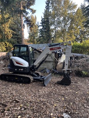 Home demolition project in Kenmore, Washington - The demolition was conducted on a 1940s era home in replacement is a four unit multi tenant property that brings character and modernization to an older neighborhood. Full demolition includes septic tank removal home demolition land clearing site, grading cleanup, site protection and final inspection.