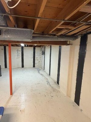 Foundation Repair in Jamesville, NY - In Jamesville, NY, a homeowner contacted us to address foundation issues before refinishing their basement. In the before photo, it's clear that the foundation was compromised, risking further damage over time. Our team installed the CarbonArmor system to provide a long-lasting solution. Using carbon fiber-reinforced polymers, CarbonArmor effectively stabilized the foundation. Notice in the after photo how the straps, combined with our advanced epoxy adhesive and ArmorLock brackets, halted any further movement, ensuring the foundation's integrity remains intact for years to come. Foundation Repair in Jamesville, NY - In Jamesville, NY, a homeowner contacted us to address foundation issues before refinishing their basement. In the before photo, it's clear that the foundation was compromised, risking further damage over time. Our team installed the CarbonArmor system to provide a long-lasting solution. Using carbon fiber-reinforced polymers, CarbonArmor effectively stabilized the foundation. Notice in the after photo how the straps, combined with our advanced epoxy adhesive and ArmorLock brackets, halted any further movement, ensuring the foundation's integrity remains intact for years to come.
