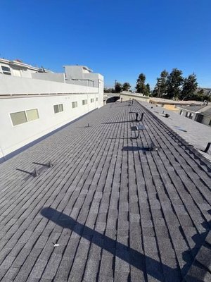 Apartment Complex Roof Replacement — Gray Shingles - Multi-building reroof completed with new gray architectural shingles. Photos highlight straight, consistent shingle courses across large roof planes, clean ridge/hip cap finishing, and neatly sealed roof penetrations (vents/pipe boots). Tie-ins and transitions between roof sections were finished for a uniform, watertight result. Apartment Complex Roof Replacement — Gray Shingles - Multi-building reroof completed with new gray architectural shingles. Photos highlight straight, consistent shingle courses across large roof planes, clean ridge/hip cap finishing, and neatly sealed roof penetrations (vents/pipe boots). Tie-ins and transitions between roof sections were finished for a uniform, watertight result.