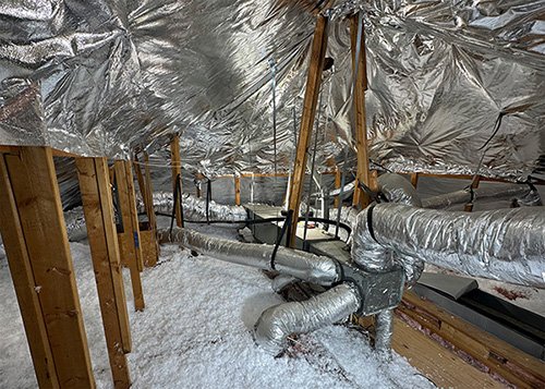 Radiant Barrier Installation in Frisco, Texas - This home in Frisco, Texas was suffering from extreme heat gain in the attic space which was transferring into all the living spaces below causing the air conditioning system to run all day to cool off the home. In less than a day, we installed RadiantGUARD® Xtreme radiant barrier to the underside of all the roof areas and to the gable wall and then blew in additional fiberglass insulation to the attic floor. The homeowner noticed a significant reduction in kWh usage beginning the day of installation! Radiant Barrier Installation in Frisco, Texas - This home in Frisco, Texas was suffering from extreme heat gain in the attic space which was transferring into all the living spaces below causing the air conditioning system to run all day to cool off the home. In less than a day, we installed RadiantGUARD® Xtreme radiant barrier to the underside of all the roof areas and to the gable wall and then blew in additional fiberglass insulation to the attic floor. The homeowner noticed a significant reduction in kWh usage beginning the day of installation!