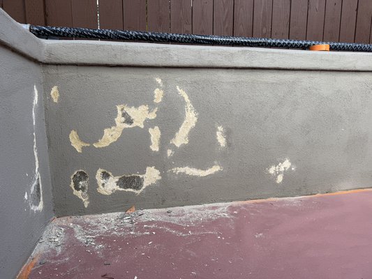 Exterior Stucco patch - We took this, beat up, retaining wall primed and patched it, and finished it with a code of duration paint ￼