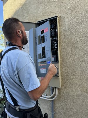 Residential Safety Services - This home had several items the customer requested we improve the safety upon. We installed a whole panel surge protector that comes with a 10-year $50,000.00 manufacturer warranty against power surge (now required by code to be installed in new main meter panels), replaced an exterior GFI cover and switch cover as well as applied silicone to create a water-proof barrier, and installed a Ring security camera with an accompanying solar panel to provide natural power to the system. Ask us how we can improve the safety of your home's electrical system! Residential Safety Services - This home had several items the customer requested we improve the safety upon. We installed a whole panel surge protector that comes with a 10-year $50,000.00 manufacturer warranty against power surge (now required by code to be installed in new main meter panels), replaced an exterior GFI cover and switch cover as well as applied silicone to create a water-proof barrier, and installed a Ring security camera with an accompanying solar panel to provide natural power to the system. Ask us how we can improve the safety of your home's electrical system!