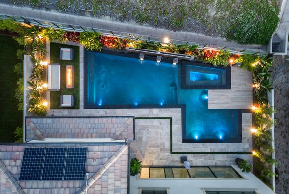 Irvine Pool Build - This modern luxury pool in Irvine epitomizes elegance and functionality, perfectly integrated into a compact backyard space. The geometric design maximizes every inch, featuring a sleek perimeter overflow that creates a seamless visual extension of the pool deck. The carefully placed LED lighting accentuates the pool’s clean lines, transforming the area into a tranquil oasis at night. A built-in fire feature adds warmth and ambiance, making this outdoor space ideal for both relaxing and entertaining. Irvine Pool Build - This modern luxury pool in Irvine epitomizes elegance and functionality, perfectly integrated into a compact backyard space. The geometric design maximizes every inch, featuring a sleek perimeter overflow that creates a seamless visual extension of the pool deck. The carefully placed LED lighting accentuates the pool’s clean lines, transforming the area into a tranquil oasis at night. A built-in fire feature adds warmth and ambiance, making this outdoor space ideal for both relaxing and entertaining.