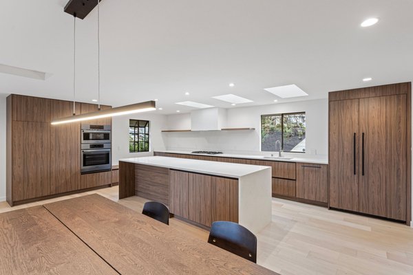 Kitchen Remodel Bellevue - Project Overview & Goals: Our goal was to transform a closed-off floor plan into a spacious, light-filled dream kitchen. To create a seamless open-concept design, we removed dividing walls, framed and installed three 24" x 48" skylights, installed engineered shear walls, secured all municipal permits, and fully upgraded the electrical, plumbing, insulation, and gas utilities to support an expanded kitchen layout.
Behind the Scenes: With engineered plans approved, we kicked off full demolition by clearing out outdated cabinets, flooring, and non-structural walls. We replaced old insulation, reinforced the framing for shear walls and skylight openings, and completely updated the core utility infrastructure for the new kitchen design. Once the trade rough-ins were complete, we installed subflooring, high-efficiency insulation, and finished drywall, highlighted by a custom-built, seamlessly integrated drywall range hood enclosure.
The Finished Kitchen: A bright, high-end modern kitchen built for culinary function and elegant entertaining. The final transformation features custom flat-panel cabinetry, a stunning quartz waterfall island, premium integrated appliances, engineered hardwood flooring, and abundant natural light streaming in from the new skylights.
We are remodeling contractors specializing in kitchen remodeling, bathroom remodeling and full home remodeling across Bellevue, Kirkland, and surrounding areas. Contact us today for free consultation. Kitchen Remodel Bellevue - Project Overview & Goals: Our goal was to transform a closed-off floor plan into a spacious, light-filled dream kitchen. To create a seamless open-concept design, we removed dividing walls, framed and installed three 24" x 48" skylights, installed engineered shear walls, secured all municipal permits, and fully upgraded the electrical, plumbing, insulation, and gas utilities to support an expanded kitchen layout.
Behind the Scenes: With engineered plans approved, we kicked off full demolition by clearing out outdated cabinets, flooring, and non-structural walls. We replaced old insulation, reinforced the framing for shear walls and skylight openings, and completely updated the core utility infrastructure for the new kitchen design. Once the trade rough-ins were complete, we installed subflooring, high-efficiency insulation, and finished drywall, highlighted by a custom-built, seamlessly integrated drywall range hood enclosure.
The Finished Kitchen: A bright, high-end modern kitchen built for culinary function and elegant entertaining. The final transformation features custom flat-panel cabinetry, a stunning quartz waterfall island, premium integrated appliances, engineered hardwood flooring, and abundant natural light streaming in from the new skylights.
We are remodeling contractors specializing in kitchen remodeling, bathroom remodeling and full home remodeling across Bellevue, Kirkland, and surrounding areas. Contact us today for free consultation.