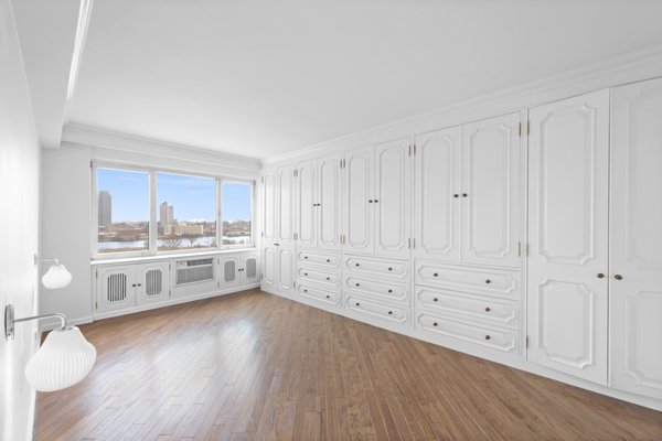 Sutton Place Apartment Renovation and Combination - Modern Citi Group helped Andrew and Malabika in their renovation journey, as they sought to transform their 2,400 sq ft apartment in Sutton Place.

This comprehensive renovation project encompassed both architectural and construction components. On the architectural front, it involved a legal combination of the two units and layout adjustments to enhance the overall functionality, create an open floor plan and improve the flow of the residence. The construction aspect of the remodel included all areas of the home: the kitchen and dining room, the living room, three bedrooms, the master bathroom, a powder room, and an office/den.

Throughout the renovation process, the primary objective remained to modernize the apartment while ensuring it aligned with the family’s lifestyle and needs. The design challenge was to deliver the modern aesthetics and functionality while preserving some of the existing design features. The designers worked on several layouts and design visualizations so they had options. Finally, the choice was made and the family felt confident in their decision.

From the moment the permits were approved, our construction team set out to transform every corner of this space. During the building phase, we meticulously refinished floors, walls, and ceilings, replaced doors, and updated electrical and plumbing systems.

The main focus of the renovation was to create a seamless flow between the living room, formal dining room, and open kitchen. A stunning waterfall peninsula with pendant lighting, along with Statuario Nuvo Quartz countertop and backsplash, elevated the aesthetics. Matte white cabinetry was added to enhance functionality and storage in the newly remodeled kitchen.

The three bedrooms were elevated with refinished built-in wardrobes and custom closet solutions, adding both usability and elegance. The fully reconfigured master suite bathroom, included a linen closet, elegant Beckett double vanity, MSI Crystal Bianco wall and floor tile, and high-end Delta and Kohler fixtures.

In addition to the comprehensive renovation of the living spaces, we've also transformed the office/entertainment room with the same great attention to detail. Complete with a sleek wet bar featuring a wine fridge, Empira White countertop and backsplash, and a convenient adjacent laundry area with a renovated powder room.

In a matter of several months, Modern Citi Group has redefined luxury living through this meticulous remodel, ensuring every inch of the space reflects unparalleled sophistication, modern functionality, and the unique taste of its owners.