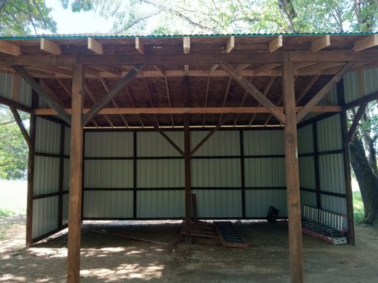 Open front post and beam horse stable - These folks had an old stable that was nearly dilapidated. We designed an open faced horse stable that in its features represented the one our client’s grandfather had built over half a century ago. With 12’ walls and 30’ long these horses will have a safe and spacious place to sleep and winter. Our clients will also be able to look out there window and see into the stable.