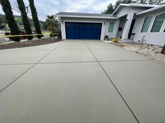 New Concrete Driveway - This project features a newly poured concrete driveway with clean expansion joints and a smooth broom finish for durability and slip resistance. The layout was carefully measured and leveled to ensure proper drainage and long-term performance. The fresh concrete complements the home’s modern design while providing a strong, low-maintenance surface built to last.