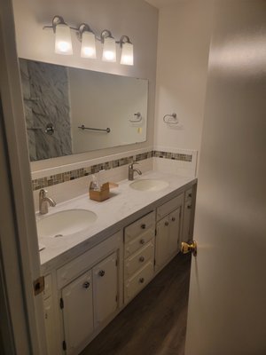 John & Sue-Bathroom Remodel - John and Sue wanted to modernize their old tile shower and floor with something new that requires minimal maintenance. We gutted their whole shower and floor then installed new slip-resistant, waterproof LVP floors and simulated stone shower walls. Then we finished it off by painting the walls and installing a new toilet. John & Sue-Bathroom Remodel - John and Sue wanted to modernize their old tile shower and floor with something new that requires minimal maintenance. We gutted their whole shower and floor then installed new slip-resistant, waterproof LVP floors and simulated stone shower walls. Then we finished it off by painting the walls and installing a new toilet.