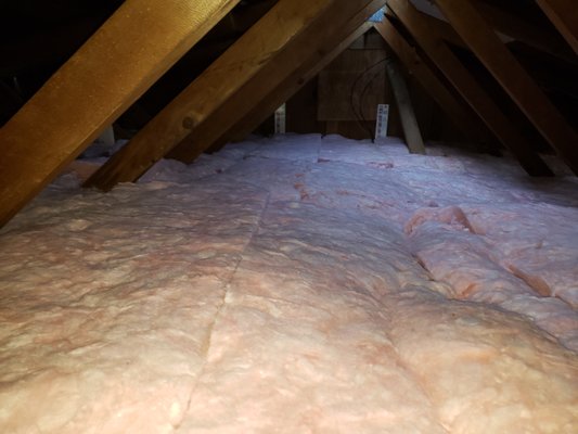 Attic Batt Insulation Install - New unfaced batt fiberglass insulation installed in an attic. Attic Batt Insulation Install - New unfaced batt fiberglass insulation installed in an attic.