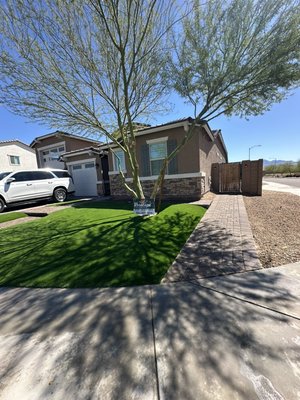 Low maintenance front yard transformation - This remodel was done with a minimal maintenance goal. We took out the old plants and installing pavers and artificial grass as well as Italian cypress and ficus columns
