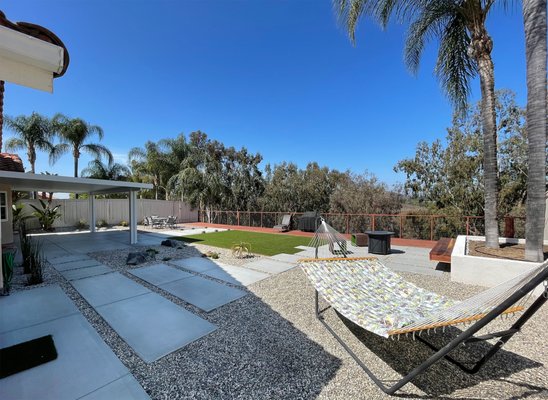 Backyard Design + Build - Poway - Backyard modern and minimalist design build project including concrete patio and pathways, alumawood patio cover, masonry+stucco walls, floating bench, artificial turf, and low maintenance landscaping.
