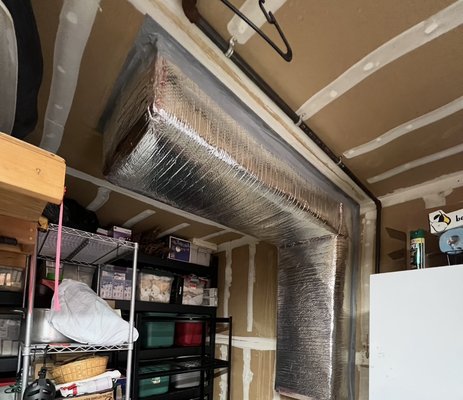Installation of exposed ducting in garage - Installed insulation on exposed HVAC ductwork in garage to improve energy efficiency, reduce temperature loss, and enhance overall system performance.”