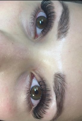 Volume Lash Set - Volume Lash Extensions
Maximum Fullness, Drama & Glamour
What are Volume Lash Extensions?
Volume lash extensions are an advanced technique that involves applying multiple ultra-fine extensions (2-8 lashes) to each individual natural lash, creating handmade "fans." This method delivers dramatic fullness, density, and glamorous results that are impossible to achieve with classic lashes alone.
Volume Techniques Available:
2D-3D Volume (Light Volume)

2-3 extensions per natural lash
Perfect for adding subtle fullness to classic sets
Natural enhancement with extra dimension

4D-5D Volume (Medium Volume)

4-5 extensions per natural lash
Noticeable fullness without being overwhelming
Great for everyday glamour

6D-8D Volume (Full Volume)

6-8 extensions per natural lash
Maximum drama and density
Red carpet, special event look

Mega Volume (10D+)

10+ extensions per natural lash
Ultimate fullness and impact
Bold, statement lashes

Key Features:
✨ Dramatic Fullness - Creates the appearance of significantly more lashes
✨ Customizable Density - Choose your level of volume from subtle to extreme
✨ Lightweight Design - Ultra-fine lashes (0.03-0.07mm) won't weigh down natural lashes
✨ Fluffy Texture - Soft, feathery appearance that looks naturally full
✨ Gap-Filling Power - Perfect for clients with sparse or thin natural lashes
✨ Instagram-Ready - Photogenic lashes that look amazing in photos
Perfect For:

Clients wanting dramatic, glamorous lashes
Those with sparse or thin natural lashes
Special events, weddings, photo shoots
Social media enthusiasts and influencers
Anyone who loves bold, statement makeup looks
Clients who want to skip mascara completely

Application Process:

Time Required: 2-3 hours for initial full set
Advanced Technique: Requires skilled technician with volume training
Precision Crafting: Each fan is handmade during application
Artistic Approach: Customized placement for optimal shape and fullness

Benefits Over Classic:

2-8x More Lashes - Exponentially fuller appearance
Better for Sparse Lashes - Fills in gaps that classic cannot
More Dramatic Results - Achieves looks impossible with classic technique
Customizable Impact - Choose exactly how full you want to go

Maintenance:

Fill appointments every 2-3 weeks
Gentle handling required due to fuller appearance
Professional lash cleansing recommended
May require slightly more careful daily maintenance

Important Considerations:

Requires healthy natural lashes to support the volume
More expensive than classic due to advanced technique and time
Best applied by certified volume technicians
May feel slightly different initially due to increased fullness

Volume lash extensions are the ultimate choice for clients who want to make a statement with their lashes - delivering unparalleled fullness, drama, and glamour that turns heads wherever you go.