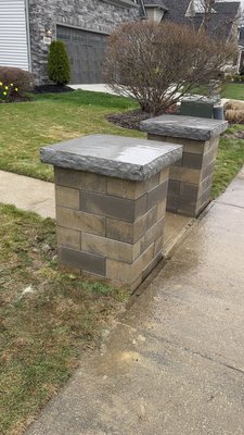 Stone Pillars - This project features a meticulously crafted stone pillar designed to enhance the entrance of a residential property. Built using premium natural stone, the pillar showcases expert masonry and a timeless aesthetic that blends seamlessly with the surrounding landscape. Standing as both a decorative and functional element, the pillar serves as a sturdy anchor for lighting and signage while adding lasting curb appeal. Our team handled every detail—from excavation and foundation work to stone selection and finishing—to ensure a durable, high-quality result that reflects the craftsmanship and attention to detail we bring to every project.