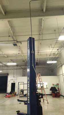 Wiring of 5 car lifts - The completed scope of work involved the wiring of five car lifts, including the relocation of existing conduit, and the wiring of four disconnects associated with the lifts. Additionally, the team wired an air compressor and secured it in place by bolting it down. The installation made efficient use of existing circuits. The project was executed with a two-year labor warranty, and the contractors were licensed and bonded. It was communicated that if the necessity to pull new circuits arose, the pricing would be subject to update.
