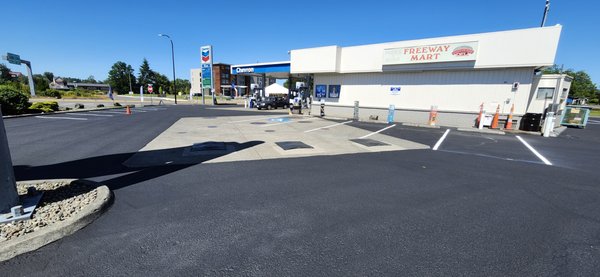 chevron gas station patch and seal - This chevron gas station not only had pot holes that were damaging vehicles but also a hazard for customers walking in the parking lot. Capital Paving and Sealcoating LLC saw cut and removed damage asphalt and replaced with hot mix asphalt and sealed seams with hot tar, Cleaning off entire parking lot and applying a commercial grade sealcoat and then restriped not only made the gas station look aesthetically pleasing but will prolong the life for many years to come and prevent any unnecessary incident. chevron gas station patch and seal - This chevron gas station not only had pot holes that were damaging vehicles but also a hazard for customers walking in the parking lot. Capital Paving and Sealcoating LLC saw cut and removed damage asphalt and replaced with hot mix asphalt and sealed seams with hot tar, Cleaning off entire parking lot and applying a commercial grade sealcoat and then restriped not only made the gas station look aesthetically pleasing but will prolong the life for many years to come and prevent any unnecessary incident.