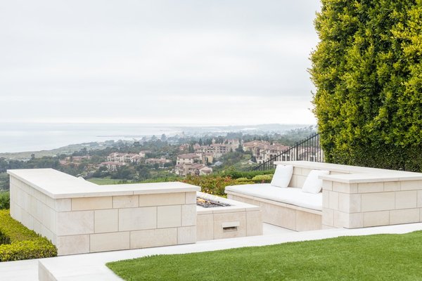 Backyard Retreat with Floating Walkways - This modern design combines architectural sophistication with serene landscaping to create a private oasis. Highlights include sleek floating stone walkways over a reflective water feature, lush greenery, and minimalist hardscaping that seamlessly blend with the contemporary architecture. A cozy fire pit area offers stunning panoramic views, while the surrounding bamboo and drought-tolerant plants enhance privacy and a sense of calm. Perfect for relaxing or entertaining, this backyard is a masterpiece of functional design and natural beauty. Discover how Haven Hub can transform your outdoor space into a personalized sanctuary.