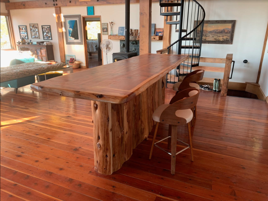 Custom Wood Furniture - We get trees form many sources. Most of our lumber is cut from trees that came down in storms or were cleared from lots or roadways. Our sources of lumber allows us to work beyond the standard sizes, shapes and types of wood that lumber dealers happen to stock. We get some exotic wood that you just can’t find in a lumberyard. We slab wood leaving the natural edge (thus the name live edge) so that the furniture we build retains the natural beauty of the living tree. We can build a project where all the solid wood is so perfectly matched for grain and color that it appears to have come from the same log—because it did.
With conventional furniture building, little effort is needed to select pieces of wood. Pieces of wood are cut and shaped to conform to needs of the end product. Building live edge furniture is a little different. When building live edge, an effort is made to follow the natural flow of the piece of wood. The wood determines the shape of the piece of furniture. This approach requires more time, but the results are well worth the effort. The end product is very natural looking and is a way of bringing nature inside.
All products that come out of our shop are created from nature in a natural way. When building live edge furniture, we try to take advantage of the natural beauty in the piece of wood and work around it to create beautiful, one-of-a-kind, hand crafted furniture.
We take great pride in building fine custom furniture. We love to take a project from drawing board to finished product. Please contact us if you would like us to build something for you. If you would like us to build something for you, allow four to six weeks, as we are a small shop and it takes the time to do it right. The wait will be worth it! Custom Wood Furniture - We get trees form many sources. Most of our lumber is cut from trees that came down in storms or were cleared from lots or roadways. Our sources of lumber allows us to work beyond the standard sizes, shapes and types of wood that lumber dealers happen to stock. We get some exotic wood that you just can’t find in a lumberyard. We slab wood leaving the natural edge (thus the name live edge) so that the furniture we build retains the natural beauty of the living tree. We can build a project where all the solid wood is so perfectly matched for grain and color that it appears to have come from the same log—because it did.
With conventional furniture building, little effort is needed to select pieces of wood. Pieces of wood are cut and shaped to conform to needs of the end product. Building live edge furniture is a little different. When building live edge, an effort is made to follow the natural flow of the piece of wood. The wood determines the shape of the piece of furniture. This approach requires more time, but the results are well worth the effort. The end product is very natural looking and is a way of bringing nature inside.
All products that come out of our shop are created from nature in a natural way. When building live edge furniture, we try to take advantage of the natural beauty in the piece of wood and work around it to create beautiful, one-of-a-kind, hand crafted furniture.
We take great pride in building fine custom furniture. We love to take a project from drawing board to finished product. Please contact us if you would like us to build something for you. If you would like us to build something for you, allow four to six weeks, as we are a small shop and it takes the time to do it right. The wait will be worth it!