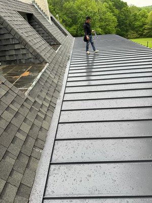 Low-Slope Standing Seam Metal Roof – Asheville, NC - This project highlights the precision required for an extremely low-slope standing seam installation. We used mechanically seamed panels to ensure long-term water tightness and durability, even on a pitch that would challenge most roofing systems. The clean lines and hidden fasteners deliver a modern, low-profile look while offering maximum performance — a true "roof upgrade" for a hardworking home. Low-Slope Standing Seam Metal Roof – Asheville, NC - This project highlights the precision required for an extremely low-slope standing seam installation. We used mechanically seamed panels to ensure long-term water tightness and durability, even on a pitch that would challenge most roofing systems. The clean lines and hidden fasteners deliver a modern, low-profile look while offering maximum performance — a true "roof upgrade" for a hardworking home.