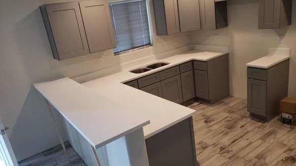 Oceana Quartz Countertops – Kitchen Remodel - This kitchen features Oceana quartz countertops, creating a bright, clean look with subtle movement and a soft, modern finish. The light tones of the quartz pair beautifully with the darker cabinetry, adding contrast while keeping the overall design warm and inviting.

Quartz countertops are a popular choice for Tucson homeowners due to their durability and low maintenance—no sealing required and easy everyday care. For this project, we completed a full countertop installation with clean edges and precise fitment, resulting in a polished, functional space designed for everyday living.