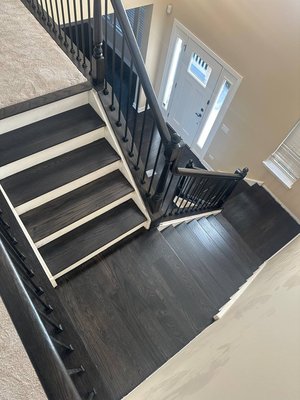 Heritage Brown Red Oak Flooring & Staircase Installation - We installed 5” Red Oak #1 Select Grade hardwood flooring, custom-finished in Heritage Brown for a warm, timeless look. The floors were sealed with two coats of premium oil-based varnish for lasting durability and rich depth of color. In addition to the flooring, we completed a hardwood staircase and railing installation, finished to match seamlessly with the flooring for a cohesive, elegant design. Heritage Brown Red Oak Flooring & Staircase Installation - We installed 5” Red Oak #1 Select Grade hardwood flooring, custom-finished in Heritage Brown for a warm, timeless look. The floors were sealed with two coats of premium oil-based varnish for lasting durability and rich depth of color. In addition to the flooring, we completed a hardwood staircase and railing installation, finished to match seamlessly with the flooring for a cohesive, elegant design.
