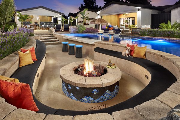 Outdoor Paradise - The client had a clear vision: to create a fun and engaging space for both their immediate family and large extended family. They often hosted large gatherings, so they wanted a space that would entertain both kids and adults, offering areas to eat, gather, and interact across all ages, while seamlessly connecting the indoors with the outdoors.
Initially, the client came to us with a design by a Disney Landscape Architect. It featured large artificial boulders, slides, a hidden shower, an outdoor room, and palm trees. While the concept was interesting, the client decided to go in a different direction, seeking something more eclectic and unique.
We worked together to develop an eclectic yet modernistic design that incorporated cement pilasters and water features, along with a tube slide in the back. The design also included a sunken firepit area next to the pool, complete with a bar for entertaining. After several iterations, we settled on a more functional design that no longer featured the water elements or slide but created a space that better served the client’s needs.
At the same time, the client had a contractor working on the house, building a theater room and a family/playroom. Pocket doors were installed to open the entire room to the backyard, creating a natural extension of the outdoor space. The contractor also handled much of the construction on the outdoor room, while we focused on certain aspects of the project.
Throughout the process, Hasmik and Sahak’s eccentric and impeccable vision guided their material selections, furniture choices, and the overall aesthetic. Their collaborative spirit, combined with the expertise of our design team, project manager, and craftsmen, led to a successful outcome. The orchestration of all these elements—balancing the eclectic design with modern functionality—was essential in ensuring that every part of the project worked together seamlessly, from the layout to the materials. Many iterations and adjustments were made along the way, and our design/build relationship allowed for flexibility and collaboration when it came to construction, materials, and design choices.
In the end, the craftsmanship led by Steven Reinoehl and the Garden View team brought the client’s vision to life, creating a space that beautifully balanced creativity, functionality, and flawless orchestration of all elements. Outdoor Paradise - The client had a clear vision: to create a fun and engaging space for both their immediate family and large extended family. They often hosted large gatherings, so they wanted a space that would entertain both kids and adults, offering areas to eat, gather, and interact across all ages, while seamlessly connecting the indoors with the outdoors.
Initially, the client came to us with a design by a Disney Landscape Architect. It featured large artificial boulders, slides, a hidden shower, an outdoor room, and palm trees. While the concept was interesting, the client decided to go in a different direction, seeking something more eclectic and unique.
We worked together to develop an eclectic yet modernistic design that incorporated cement pilasters and water features, along with a tube slide in the back. The design also included a sunken firepit area next to the pool, complete with a bar for entertaining. After several iterations, we settled on a more functional design that no longer featured the water elements or slide but created a space that better served the client’s needs.
At the same time, the client had a contractor working on the house, building a theater room and a family/playroom. Pocket doors were installed to open the entire room to the backyard, creating a natural extension of the outdoor space. The contractor also handled much of the construction on the outdoor room, while we focused on certain aspects of the project.
Throughout the process, Hasmik and Sahak’s eccentric and impeccable vision guided their material selections, furniture choices, and the overall aesthetic. Their collaborative spirit, combined with the expertise of our design team, project manager, and craftsmen, led to a successful outcome. The orchestration of all these elements—balancing the eclectic design with modern functionality—was essential in ensuring that every part of the project worked together seamlessly, from the layout to the materials. Many iterations and adjustments were made along the way, and our design/build relationship allowed for flexibility and collaboration when it came to construction, materials, and design choices.
In the end, the craftsmanship led by Steven Reinoehl and the Garden View team brought the client’s vision to life, creating a space that beautifully balanced creativity, functionality, and flawless orchestration of all elements.