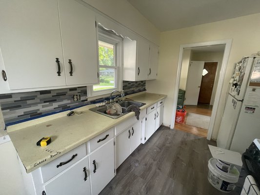 Quick backsplash update - This was a 70 year old home that I added a glass tile backsplash too. I still recommend the customer replaces the countertops too to finish it off.