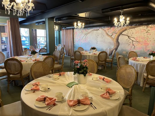Bridal Shower Banquet - Large round banquet tables were decorated with white tablecloth bows, white china place settings, and gold tone flatware. Add a Bridgerton-themed playlist, a few sprigs of Wisteria blooms, and gorgeous tea frocks. Et voila: the perfect bridal shower. Bridal Shower Banquet - Large round banquet tables were decorated with white tablecloth bows, white china place settings, and gold tone flatware. Add a Bridgerton-themed playlist, a few sprigs of Wisteria blooms, and gorgeous tea frocks. Et voila: the perfect bridal shower.