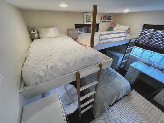Bedroom Loft - Scenario: Fit 3 people in 1 room 

Problem: As you can see in the last photo there were 3 beds on the floor. This gave little to no space for all girls to sleep, play and study comfortably. 

Solution: Build a loft style bunk bed for the younger girls above and oldest sibling down below. Hang out zone under to the left and desks along the side wall.
