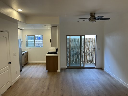 Los Angeles condominium remodeling - This was done on an old kitchen and living room remodeling we removed all the carpet and old cabinets. We painted the condominium white installed oak floors and painted rails black. This was all done in one week.