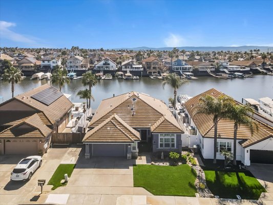 4174 Beacon Place Discovery Bay Ca 94505 - LINK TO PHOTOS AND VIDEO: https://4174beaconpl.guzzardoteamstories.com/
Welcome to a meticulously remodeled single-story waterfront home offering an unparalleled living experience designed to capture the essence of luxurious waterfront living, with access to the Delta within minutes. Upon entering the home, you are greeted by an open great room that seamlessly integrates with a chef's kitchen, perfect for both everyday living and entertaining. The kitchen has luxurious Cambia Quartz backsplash and expansive countertops with seating for six, along with upgraded appliances ensuring both functionality and style. Built-in surround sound stereo and multi-room speakers provide a sophisticated audio experience throughout the home and deck which enhances the ambiance. The property is bathed in abundant natural light, accentuating the spacious interiors, with custom shutters adding to the experience. The well-appointed primary suite has a beautiful view of the waterway with direct access to the deck. Adjacent to the primary suite is an exquisitely remodeled primary bathroom, complete with a sumptuous oversized Kohler soaking tub and generous shower. Step outside to discover the vinyl deck and dock, featuring a double U dock with two boat hoists and an aluminum dock awning for the perfect setup of a variety of boats and water toys. 4174 Beacon Place Discovery Bay Ca 94505 - LINK TO PHOTOS AND VIDEO: https://4174beaconpl.guzzardoteamstories.com/
Welcome to a meticulously remodeled single-story waterfront home offering an unparalleled living experience designed to capture the essence of luxurious waterfront living, with access to the Delta within minutes. Upon entering the home, you are greeted by an open great room that seamlessly integrates with a chef's kitchen, perfect for both everyday living and entertaining. The kitchen has luxurious Cambia Quartz backsplash and expansive countertops with seating for six, along with upgraded appliances ensuring both functionality and style. Built-in surround sound stereo and multi-room speakers provide a sophisticated audio experience throughout the home and deck which enhances the ambiance. The property is bathed in abundant natural light, accentuating the spacious interiors, with custom shutters adding to the experience. The well-appointed primary suite has a beautiful view of the waterway with direct access to the deck. Adjacent to the primary suite is an exquisitely remodeled primary bathroom, complete with a sumptuous oversized Kohler soaking tub and generous shower. Step outside to discover the vinyl deck and dock, featuring a double U dock with two boat hoists and an aluminum dock awning for the perfect setup of a variety of boats and water toys.