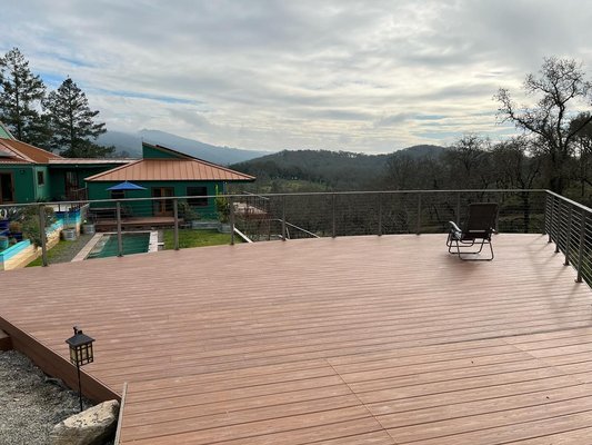 New Deck Construction - Our customer Larry wanted to add another deck on his property but he didn’t want to add just any ordinary deck. Larry wanted to be unique. This deck is 40ft wide and 22ft long and was constructed with steel posts, a pressure treated frame and trex deck boards. Larry requested a raw steel look for the guardrails with stainless steel cables. New Deck Construction - Our customer Larry wanted to add another deck on his property but he didn’t want to add just any ordinary deck. Larry wanted to be unique. This deck is 40ft wide and 22ft long and was constructed with steel posts, a pressure treated frame and trex deck boards. Larry requested a raw steel look for the guardrails with stainless steel cables.