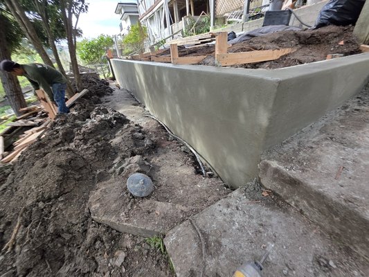 concrete retaining wall - In this project, a concrete retaining wall was built to prevent further land collapse.