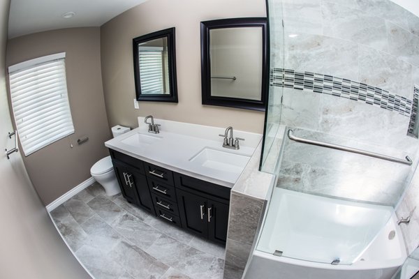 Bathroom Remodel - Model A - This is a complete bathroom remodel with new tub, a custom frameless glass shower door, custom double sink vanity, new flooring and tiles. Bathroom Remodel - Model A - This is a complete bathroom remodel with new tub, a custom frameless glass shower door, custom double sink vanity, new flooring and tiles.