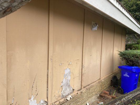 Siding replacement - This wall has been under the pressure of the sun for far too many years and was beginning to rot and peel. The project began by removing and disposing of the old rotted panels. Then they were replaced with new rockboard panels, sealed, and painted. With the use of high quality materials, and expert craftsmanship, this wall will last for far longer than it has before