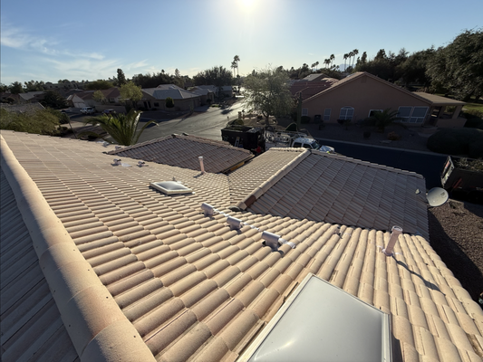 Tempe New Tile Roof - Residential tile roof replacement in progress. Existing tiles have been removed, new plywood decking is exposed, and synthetic underlayment is being installed. Concrete roof tiles are staged and ready for reinstallation, with part of the roof already completed. Tempe New Tile Roof - Residential tile roof replacement in progress. Existing tiles have been removed, new plywood decking is exposed, and synthetic underlayment is being installed. Concrete roof tiles are staged and ready for reinstallation, with part of the roof already completed.