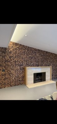 Wall finished with wooden mosaic made of Brazilian walnut. Beverly Hills, 2025. - The wall behind the fireplace was finished with a wooden mosaic made of hexagonal elements. Before installation, the level was carefully set, and the монтаж began from the top to ensure a clean ceiling line and precise geometry. The result is a stylish accent wall that beautifully highlights the fireplace area and adds warmth and character to the interior. The client was delighted with the beauty and quality of the work. Wall finished with wooden mosaic made of Brazilian walnut. Beverly Hills, 2025. - The wall behind the fireplace was finished with a wooden mosaic made of hexagonal elements. Before installation, the level was carefully set, and the монтаж began from the top to ensure a clean ceiling line and precise geometry. The result is a stylish accent wall that beautifully highlights the fireplace area and adds warmth and character to the interior. The client was delighted with the beauty and quality of the work.