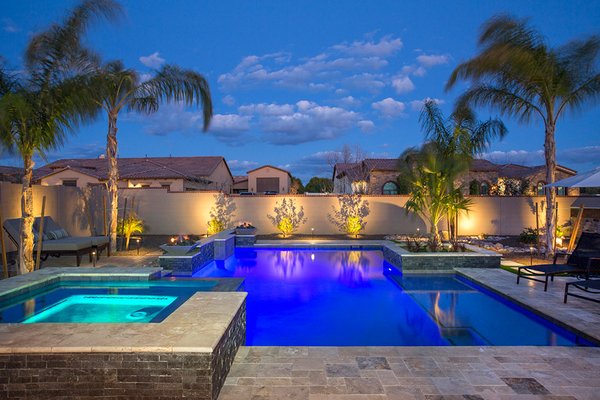 Beyond the Pool: Transforming Your Backyard with Unique Features - This isn't just a pool, it's a complete backyard transformation designed for ultimate relaxation and entertainment. Imagine flickering flames dancing in strategically placed fire bowls, casting a warm glow on your evenings. Custom planters overflowing with vibrant flowers and greenery add pops of color and life to the space. Take relaxation to a new level in the raised spa, featuring a beautiful cascading spillway that flows back into the pool, creating a soothing waterfall effect. The built-in sun shelf with playful bubblers is the perfect spot to cool off and have some fun. But the fun doesn't stop there. Multiple, strategically placed seating areas ensure there's a comfortable spot for everyone, whether you crave sunshine on the sun deck, conversation by the fire, or shaded relaxation under an umbrella. This design goes beyond the pool, creating a truly functional and inviting outdoor living space you'll never want to leave. Beyond the Pool: Transforming Your Backyard with Unique Features - This isn't just a pool, it's a complete backyard transformation designed for ultimate relaxation and entertainment. Imagine flickering flames dancing in strategically placed fire bowls, casting a warm glow on your evenings. Custom planters overflowing with vibrant flowers and greenery add pops of color and life to the space. Take relaxation to a new level in the raised spa, featuring a beautiful cascading spillway that flows back into the pool, creating a soothing waterfall effect. The built-in sun shelf with playful bubblers is the perfect spot to cool off and have some fun. But the fun doesn't stop there. Multiple, strategically placed seating areas ensure there's a comfortable spot for everyone, whether you crave sunshine on the sun deck, conversation by the fire, or shaded relaxation under an umbrella. This design goes beyond the pool, creating a truly functional and inviting outdoor living space you'll never want to leave.