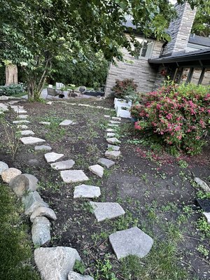 Mulch bed transformation - This transformation was well needed. The owner had lost track of his old mulch bed. Rain was causing dirt to wash down into the lawn. Once he decided on his rock of choice we began tearing out all of his weeds and a few plants. Installing a 10mm layer of polly throughout the entire bed. Mulch bed transformation - This transformation was well needed. The owner had lost track of his old mulch bed. Rain was causing dirt to wash down into the lawn. Once he decided on his rock of choice we began tearing out all of his weeds and a few plants. Installing a 10mm layer of polly throughout the entire bed.