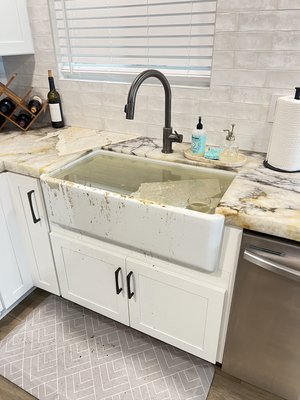 Kitchen Sink Clog Before and After - What started as a clogged kitchen sink quickly turned into a leak running down into the parking garage. Our techs located the blockage, cleared the line, stopped the leak, and cleaned up all affected areas. Reliable service from a team that takes care of the whole problem, not just part of it.