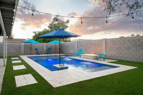 Sleek & Social: Linear Pool with Inviting Lounge Area - Turn your backyard into the ultimate gathering spot with this sleek and social pool design. Dive into crystal-clear water surrounded by exquisite blue marbled tile, accented with stunning glass bead inlay details for a touch of luxury. Enjoy friends and family with the built-in pool table, seamlessly integrated right in the pool for endless fun. After the sun sets, gather around the modern fire pit for warmth, conversation, and unforgettable evenings under the stars. Pavers create a clean and polished look around the pool, while the astro turf lounge area provides a comfortable and stylish space to relax and soak up the sun. This pool design is perfect for those who love to entertain and create lasting memories with loved ones. Sleek & Social: Linear Pool with Inviting Lounge Area - Turn your backyard into the ultimate gathering spot with this sleek and social pool design. Dive into crystal-clear water surrounded by exquisite blue marbled tile, accented with stunning glass bead inlay details for a touch of luxury. Enjoy friends and family with the built-in pool table, seamlessly integrated right in the pool for endless fun. After the sun sets, gather around the modern fire pit for warmth, conversation, and unforgettable evenings under the stars. Pavers create a clean and polished look around the pool, while the astro turf lounge area provides a comfortable and stylish space to relax and soak up the sun. This pool design is perfect for those who love to entertain and create lasting memories with loved ones.