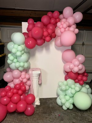 Spring Blossom Balloon Arch - This vibrant and whimsical balloon backdrop features a stunning combination of pink, mint green, and coral shades. Perfect for baby showers, birthdays, or spring-themed celebrations, the design exudes a playful yet elegant charm. The organic style arrangement creates a dynamic and textured look, beautifully complementing any event space. Spring Blossom Balloon Arch - This vibrant and whimsical balloon backdrop features a stunning combination of pink, mint green, and coral shades. Perfect for baby showers, birthdays, or spring-themed celebrations, the design exudes a playful yet elegant charm. The organic style arrangement creates a dynamic and textured look, beautifully complementing any event space.