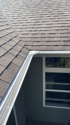 Leaf Protection Gutters - Leaf Protection for Your Michigan Gutters
Your home’s gutters and downspouts are essential for redirecting water and moisture away from your home’s foundation. Therefore, it’s important to keep them clear of leaves and other debris that could prevent them from doing their job effectively. Most homeowners do not enjoy cleaning their gutters. This can be a messy and sometimes dangerous task, as it often requires going up on a ladder during unpleasant weather conditions. However, that’s where leaf guards for gutters offer assistance.
Available in many styles and materials, leaf guards help you reduce your annual gutter maintenance needs, which is good news for the average homeowner desiring a relatively maintenance-free gutter system. Leaf guards also help prevent water overflow during Michigan’s rainy season while collecting clean rainwater for the more environmentally-conscious homeowners among us. Weather Vane Roofing provides three main types of leaf protection for gutters in the Lansing, Howell, Brighton, Owosso and Grand Haven area, including Leafsmart Gutter Guards, Micro-Mesh Gutter Guards, and Evelyn’s Leaf Solution Gutter Guards. Leaf Protection Gutters - Leaf Protection for Your Michigan Gutters
Your home’s gutters and downspouts are essential for redirecting water and moisture away from your home’s foundation. Therefore, it’s important to keep them clear of leaves and other debris that could prevent them from doing their job effectively. Most homeowners do not enjoy cleaning their gutters. This can be a messy and sometimes dangerous task, as it often requires going up on a ladder during unpleasant weather conditions. However, that’s where leaf guards for gutters offer assistance.
Available in many styles and materials, leaf guards help you reduce your annual gutter maintenance needs, which is good news for the average homeowner desiring a relatively maintenance-free gutter system. Leaf guards also help prevent water overflow during Michigan’s rainy season while collecting clean rainwater for the more environmentally-conscious homeowners among us. Weather Vane Roofing provides three main types of leaf protection for gutters in the Lansing, Howell, Brighton, Owosso and Grand Haven area, including Leafsmart Gutter Guards, Micro-Mesh Gutter Guards, and Evelyn’s Leaf Solution Gutter Guards.