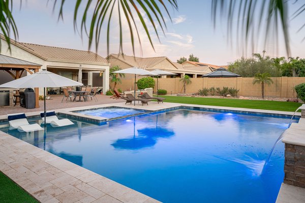 Modern Oasis: Pool, Spa & Water Features - This stunning modern pool design creates a luxurious escape in your own backyard. Imagine dipping into a flush spa, seamlessly integrated with the pool, for ultimate relaxation. Sheer descent water features, cascading down from the edge of the pool, add a touch of tranquility and visual interest. For lounging and entertaining, a spacious sun shelf with comfortable seating offers the perfect spot to soak up the sun. Step off the sun shelf onto a luxurious astro turf lounge area, perfect for poolside gatherings and adding a touch of green without the maintenance of real grass. This modern pool design is all about creating a beautiful and functional space for relaxation, rejuvenation, and entertaining. Modern Oasis: Pool, Spa & Water Features - This stunning modern pool design creates a luxurious escape in your own backyard. Imagine dipping into a flush spa, seamlessly integrated with the pool, for ultimate relaxation. Sheer descent water features, cascading down from the edge of the pool, add a touch of tranquility and visual interest. For lounging and entertaining, a spacious sun shelf with comfortable seating offers the perfect spot to soak up the sun. Step off the sun shelf onto a luxurious astro turf lounge area, perfect for poolside gatherings and adding a touch of green without the maintenance of real grass. This modern pool design is all about creating a beautiful and functional space for relaxation, rejuvenation, and entertaining.