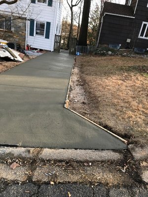 Concrete Driveway - This is a concrete driveway made with a two-inch #57 gravel base and a thickness of 5 inches. It is a professionally done job.
